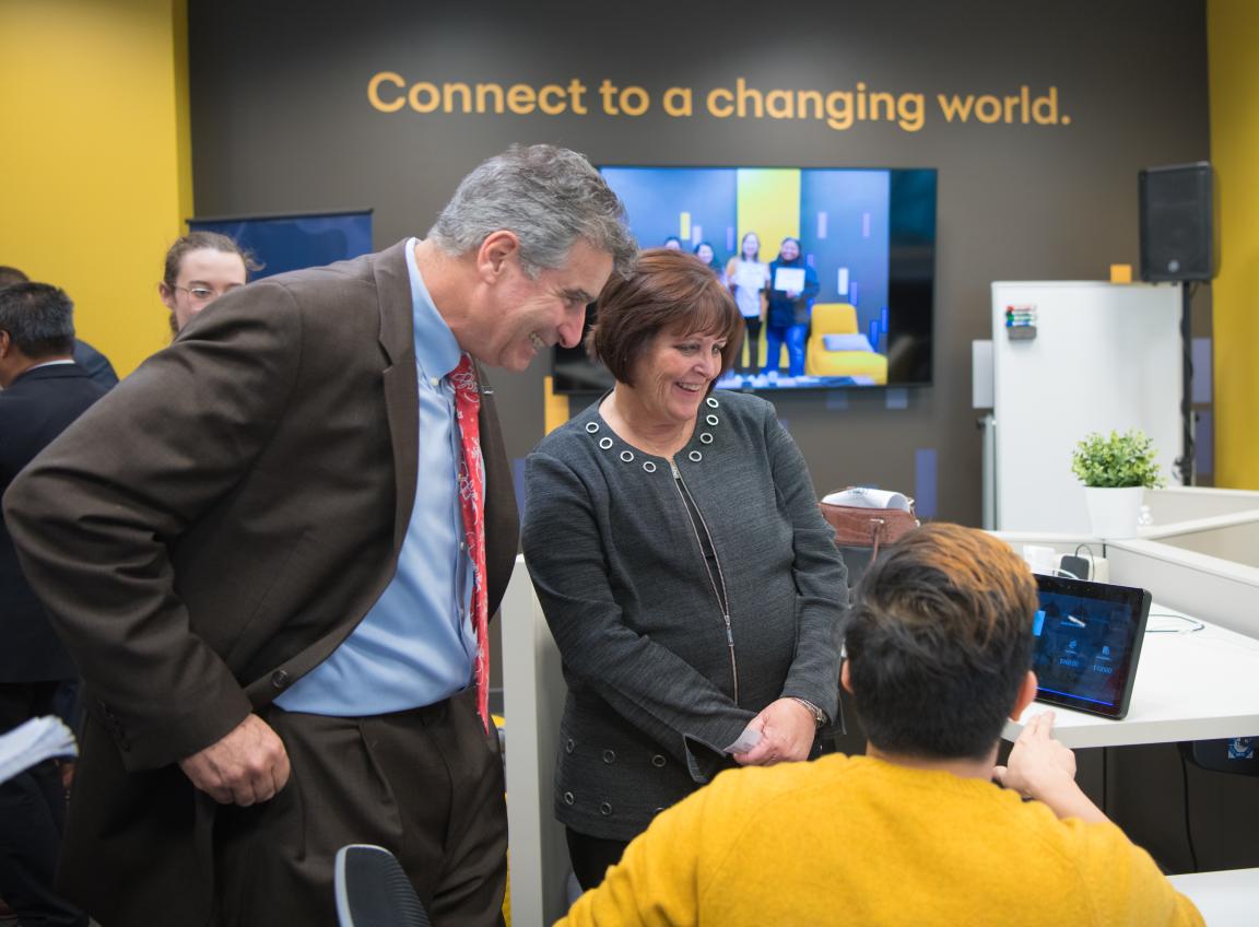 Man and woman looking at tech demo on tablet