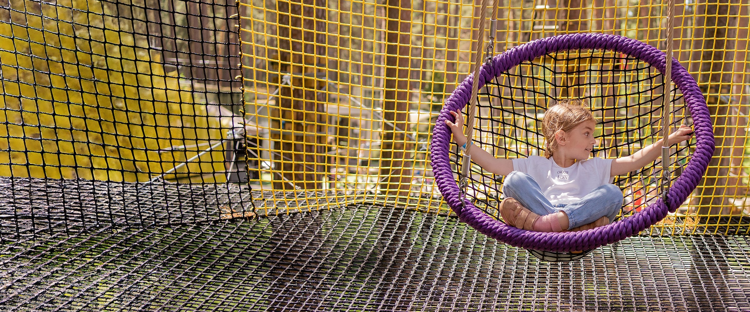 Photo of young girl in a net like swing.