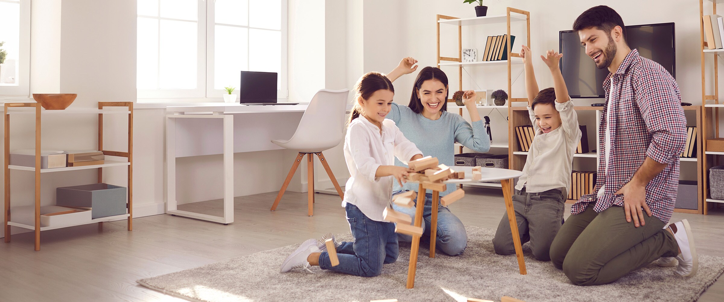 Photo of family playing a board game at a table.