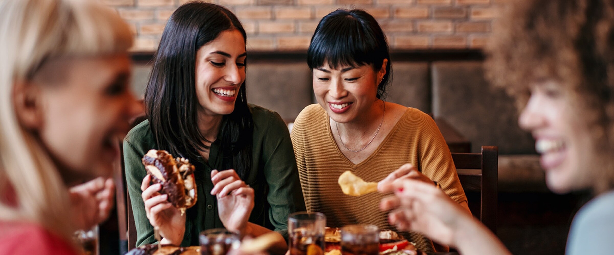 Photo of four women enjoying tapas at a restaurant table.