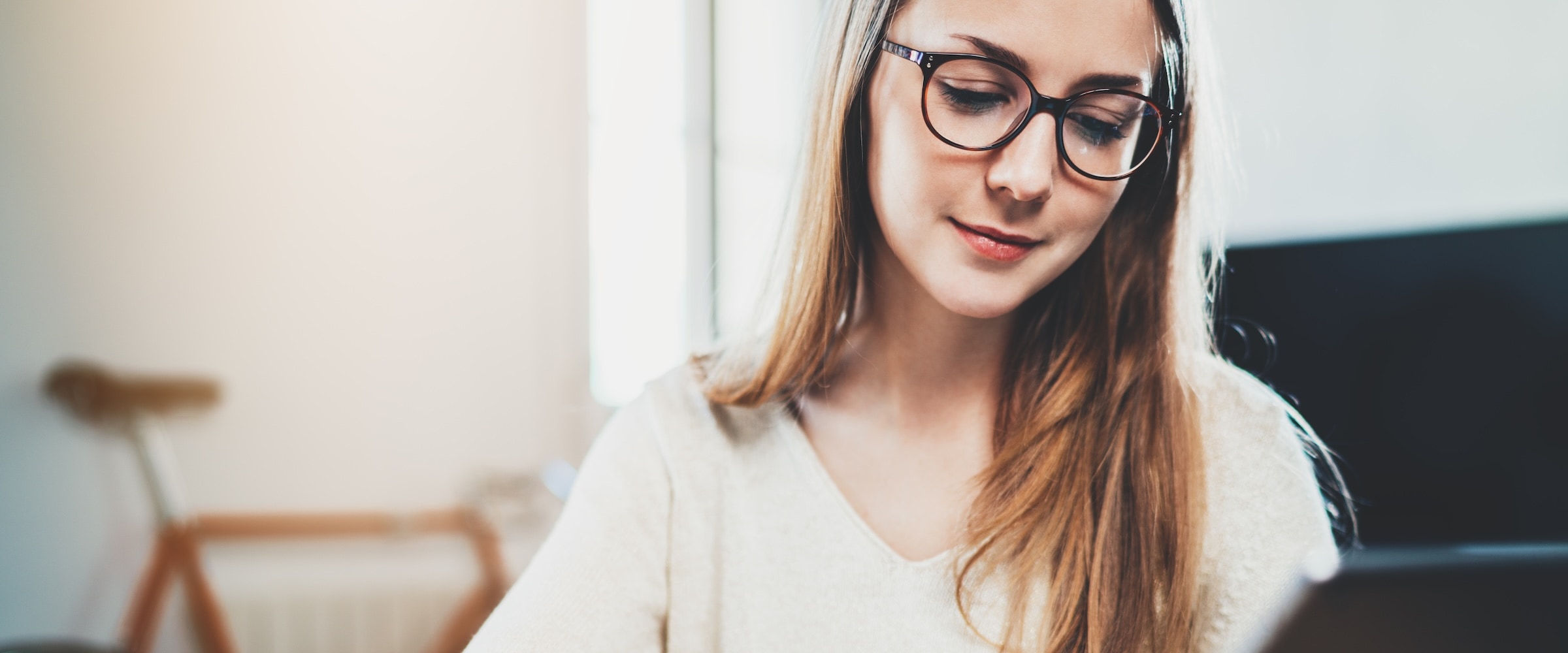 Photo of young woman looking at her computer.
