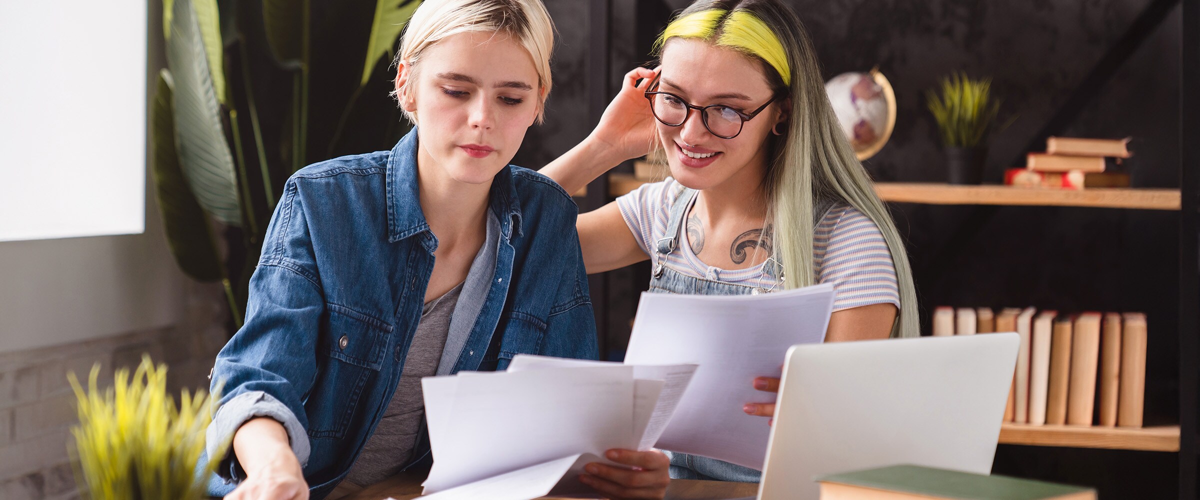 Photo of a female couple working on taxes.