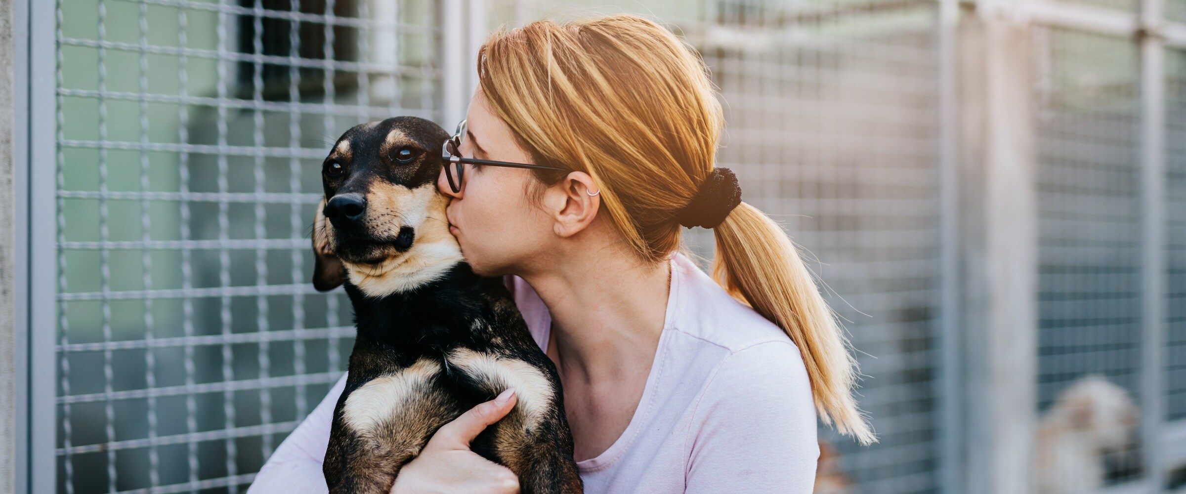 Photo of a woman hugging her pet.
