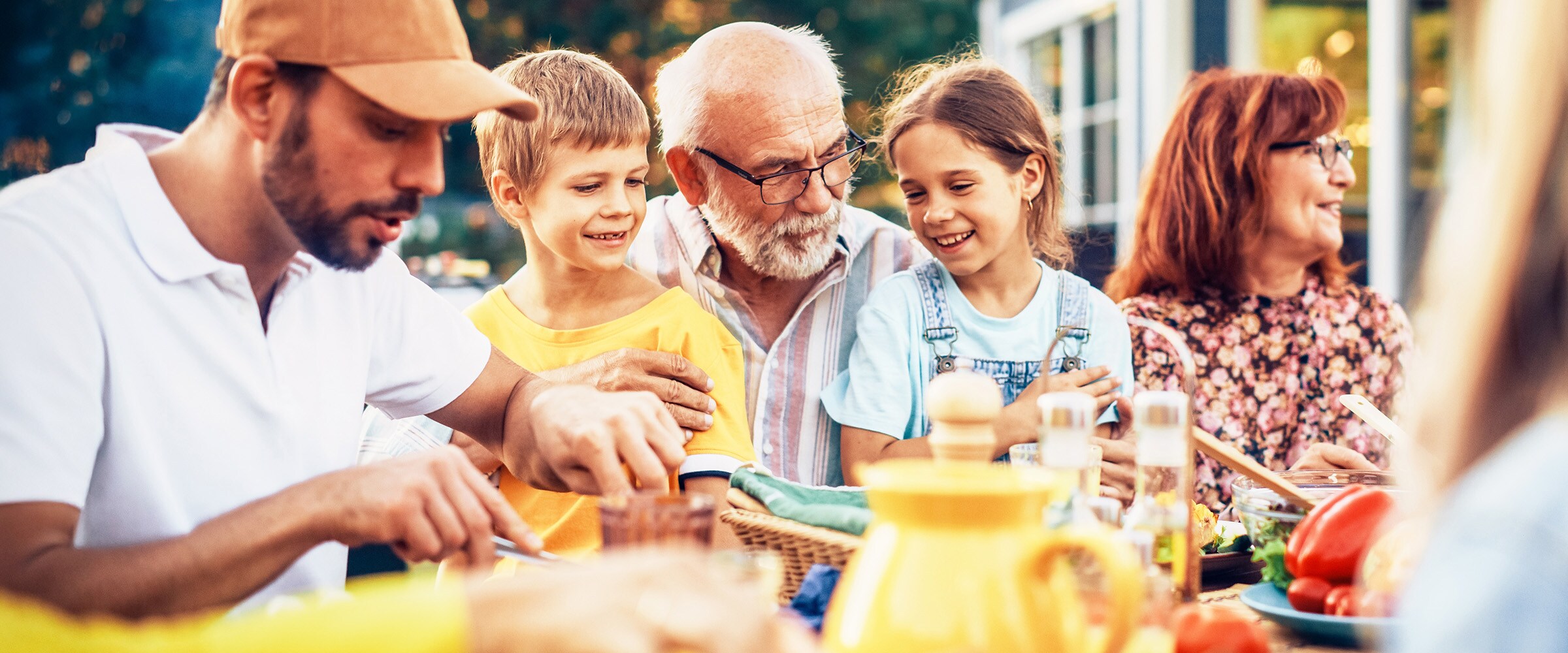 Photo of the generations of a family sitting at a table.