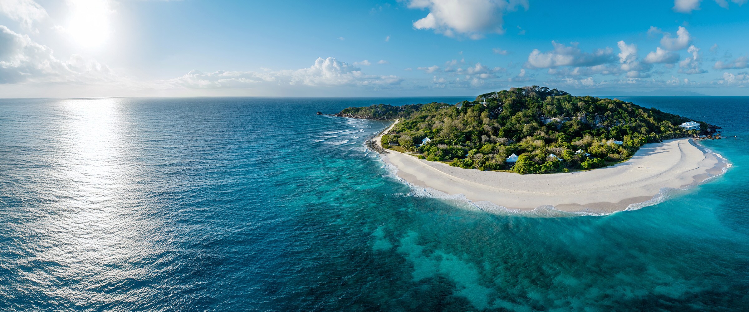 Photo of an island surrounded by deep blue water.