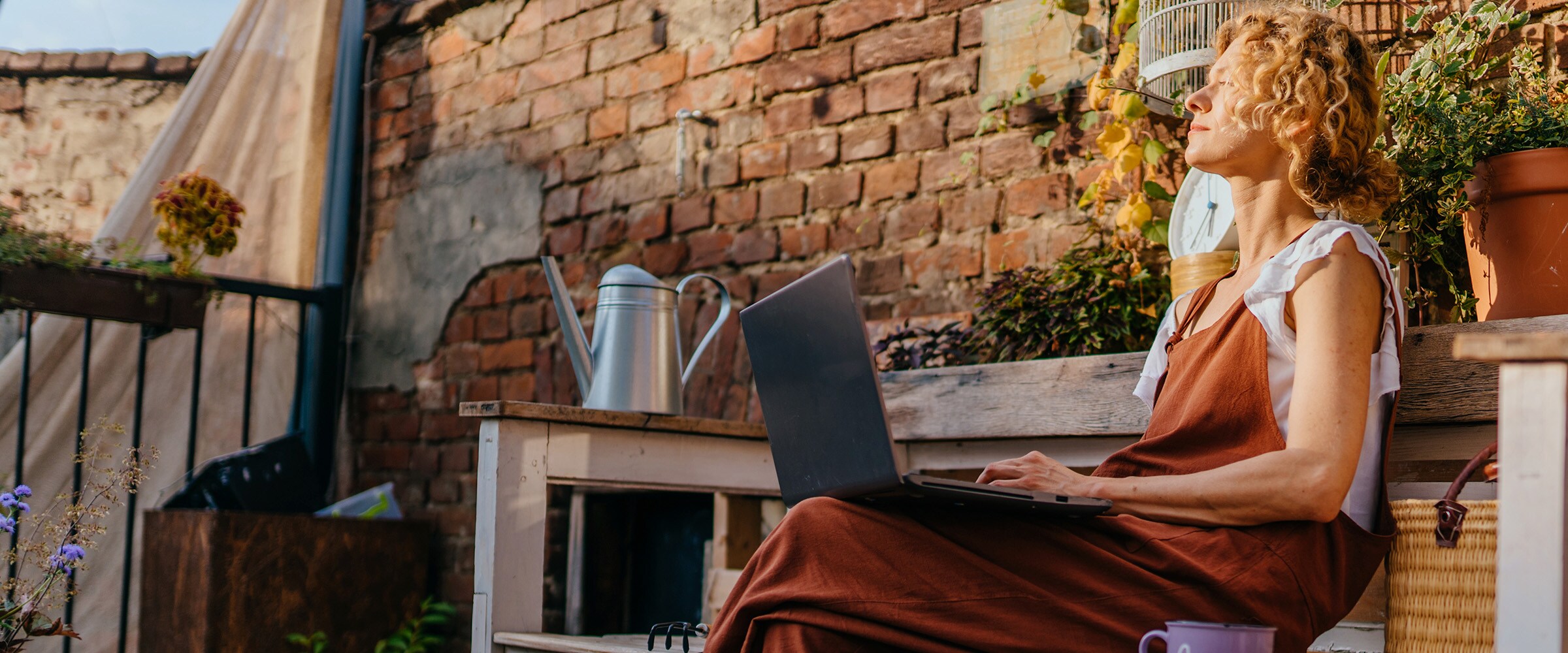Photo of a Gen X Woman sitting outside with the sun in her face.