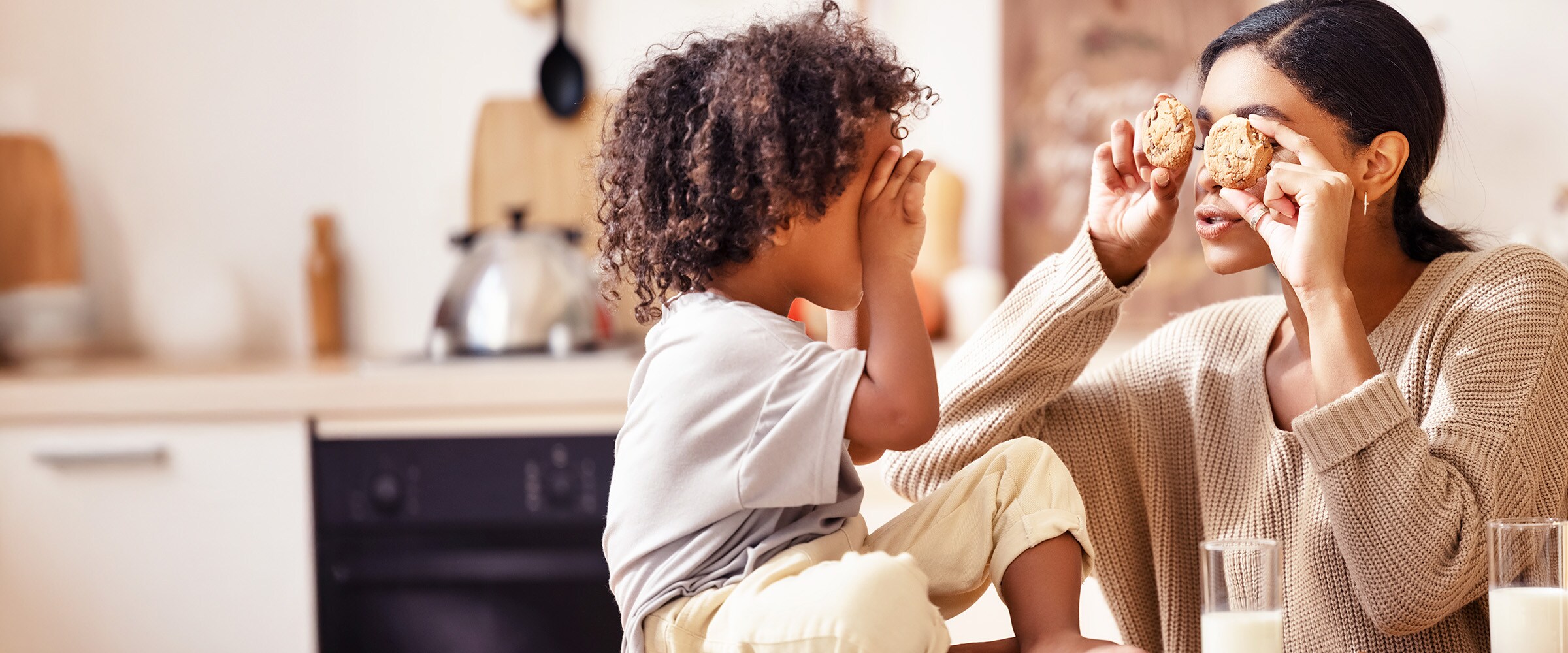 Photo of Mom and child holding cookies up to their eyes like glasses.