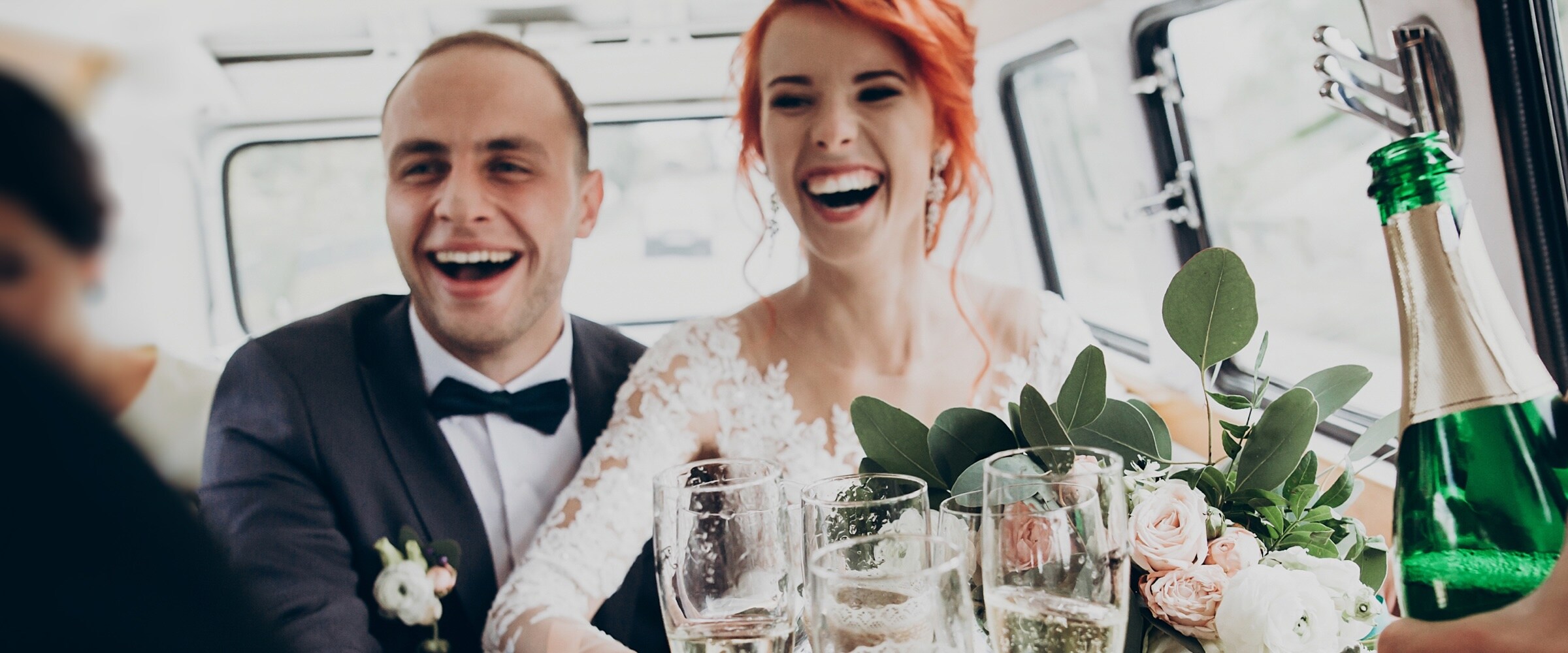 Photo of newlyweds in back of limo with champagne.