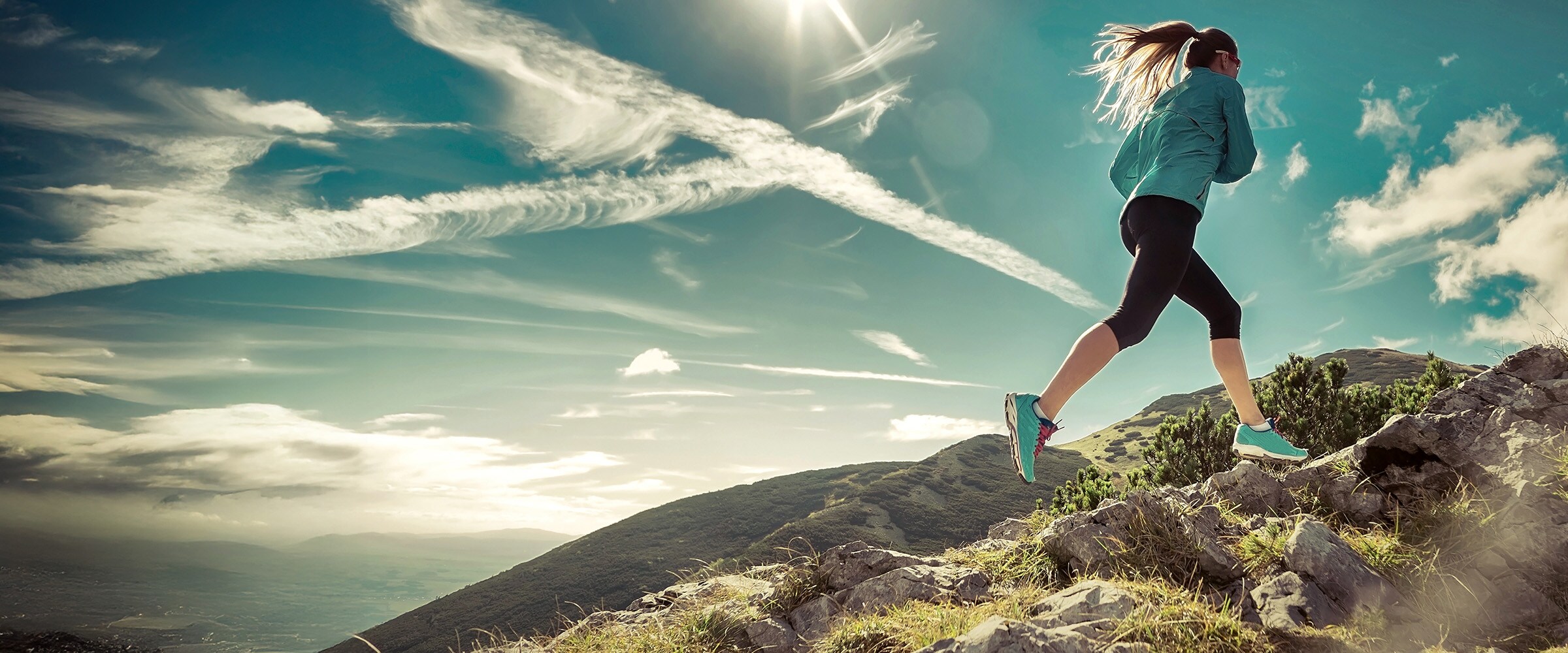 Photo of woman running up a hill.