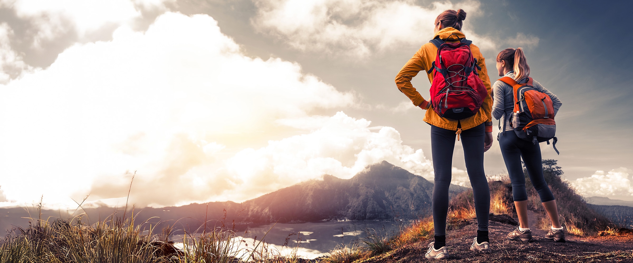 Photo of two women on top of mountain ridge.
