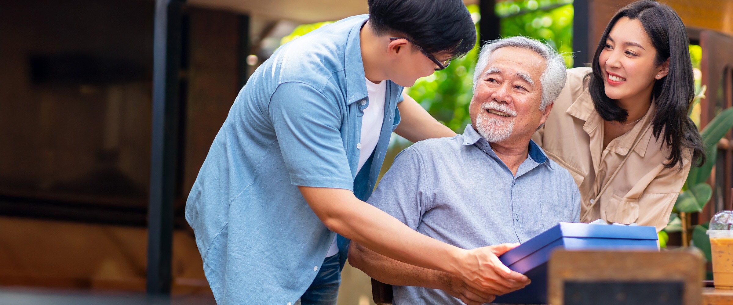 Photo of two children leaning in close to older parent.