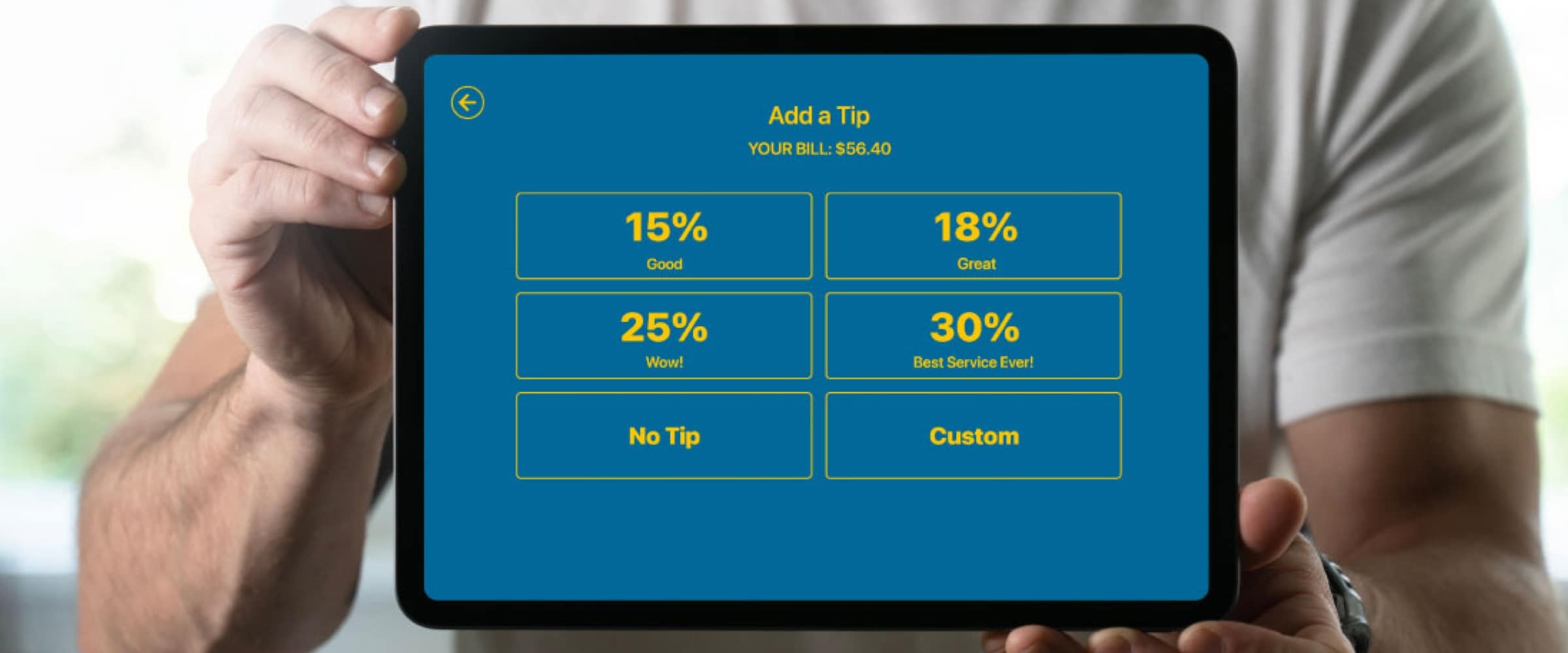 Photo of man holding up an iPad with tipping options.