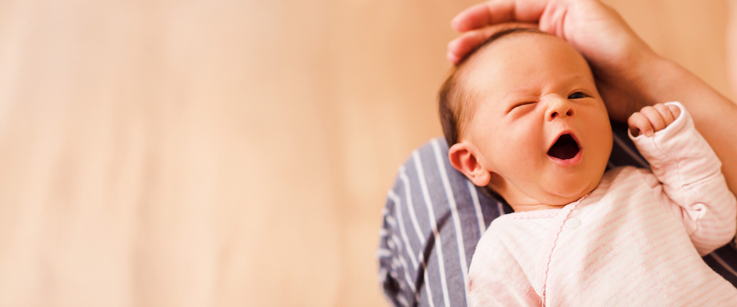 Photo of a newborn wrapped in a blanket.