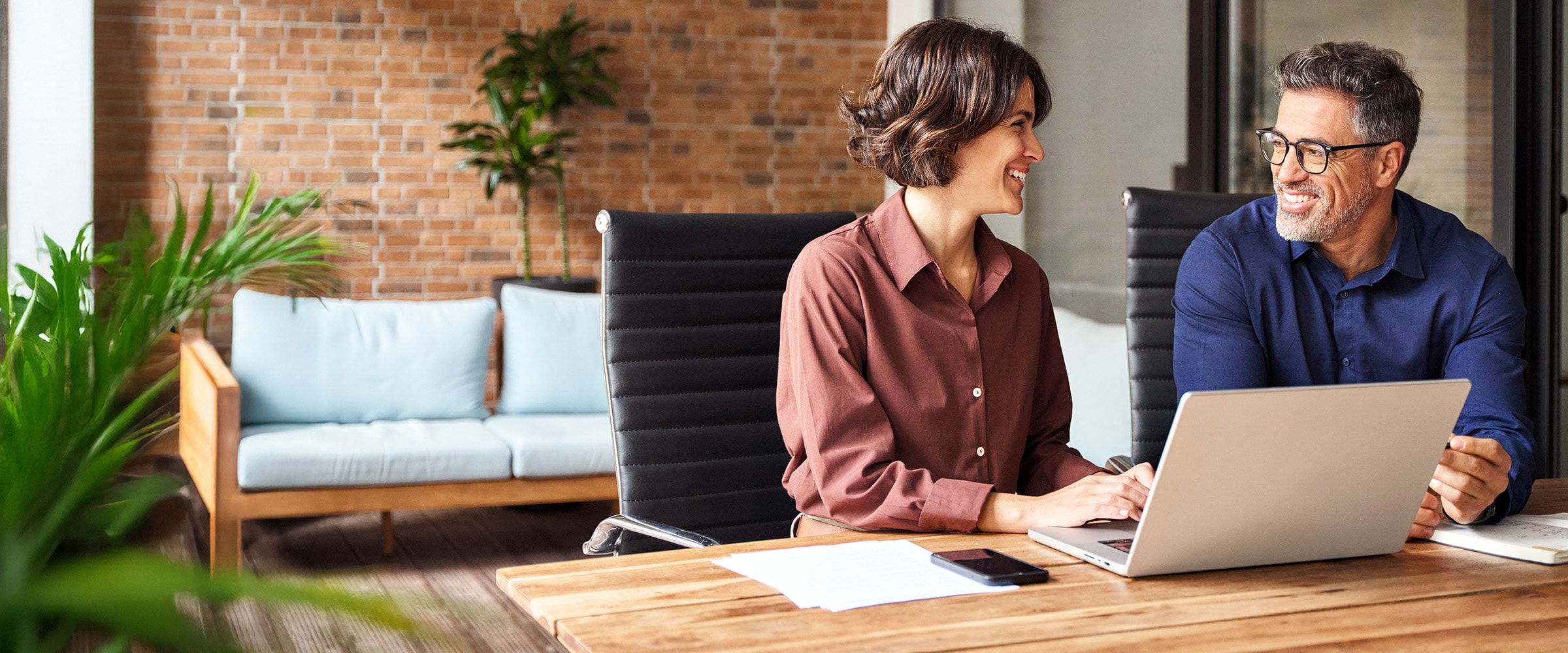 Photo of man and woman talking with each other at a table.
