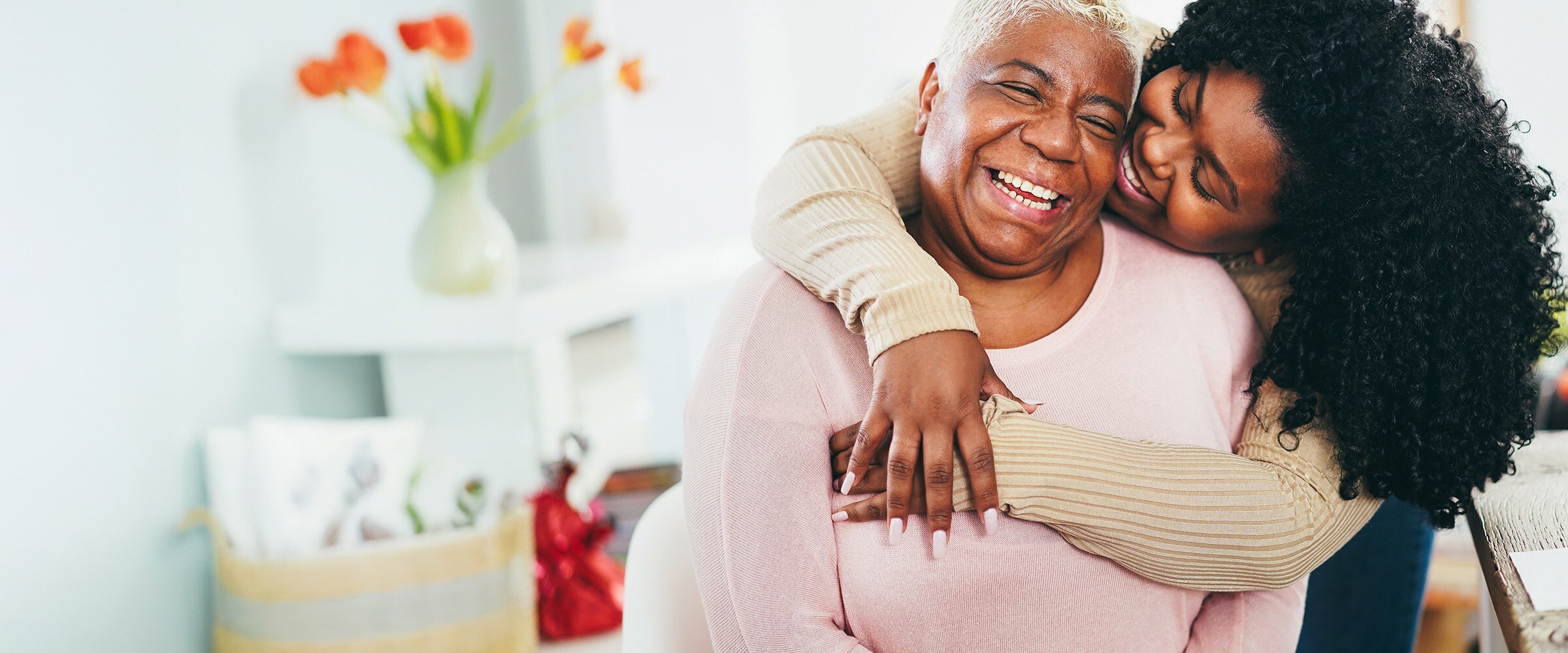 Photo of woman hugging her older mother.