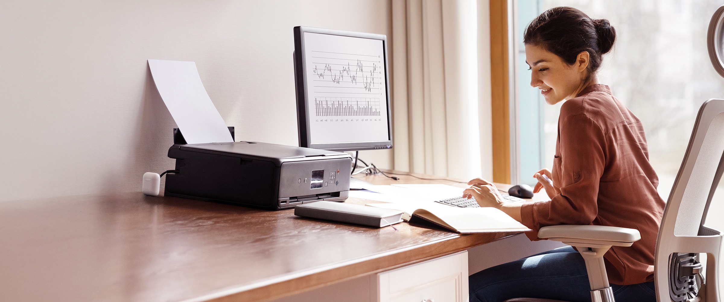 Photo of woman working at home office.